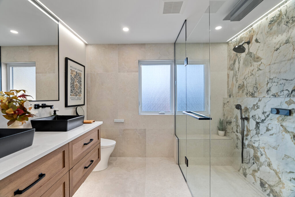 Modern bathroom renovation with custom cabinetry, tile and coordinated finishes