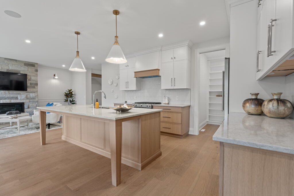 Kitchen design and installation services featuring custom cabinetry, quartz countertops and a large island