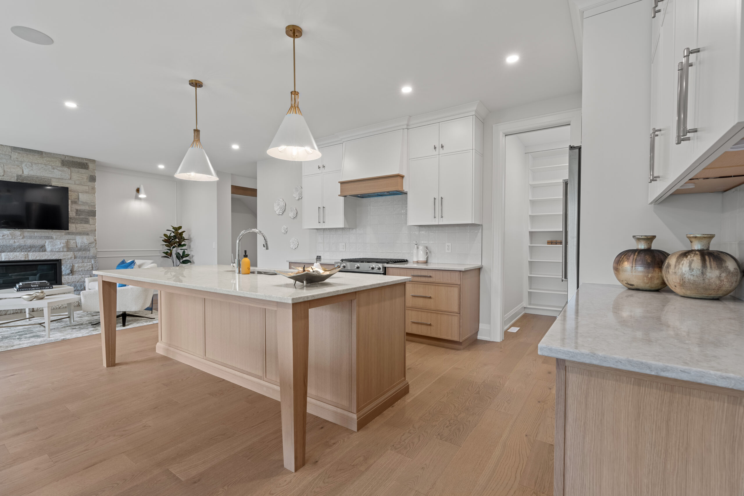 Kitchen design and installation services featuring custom cabinetry, quartz countertops and a large island